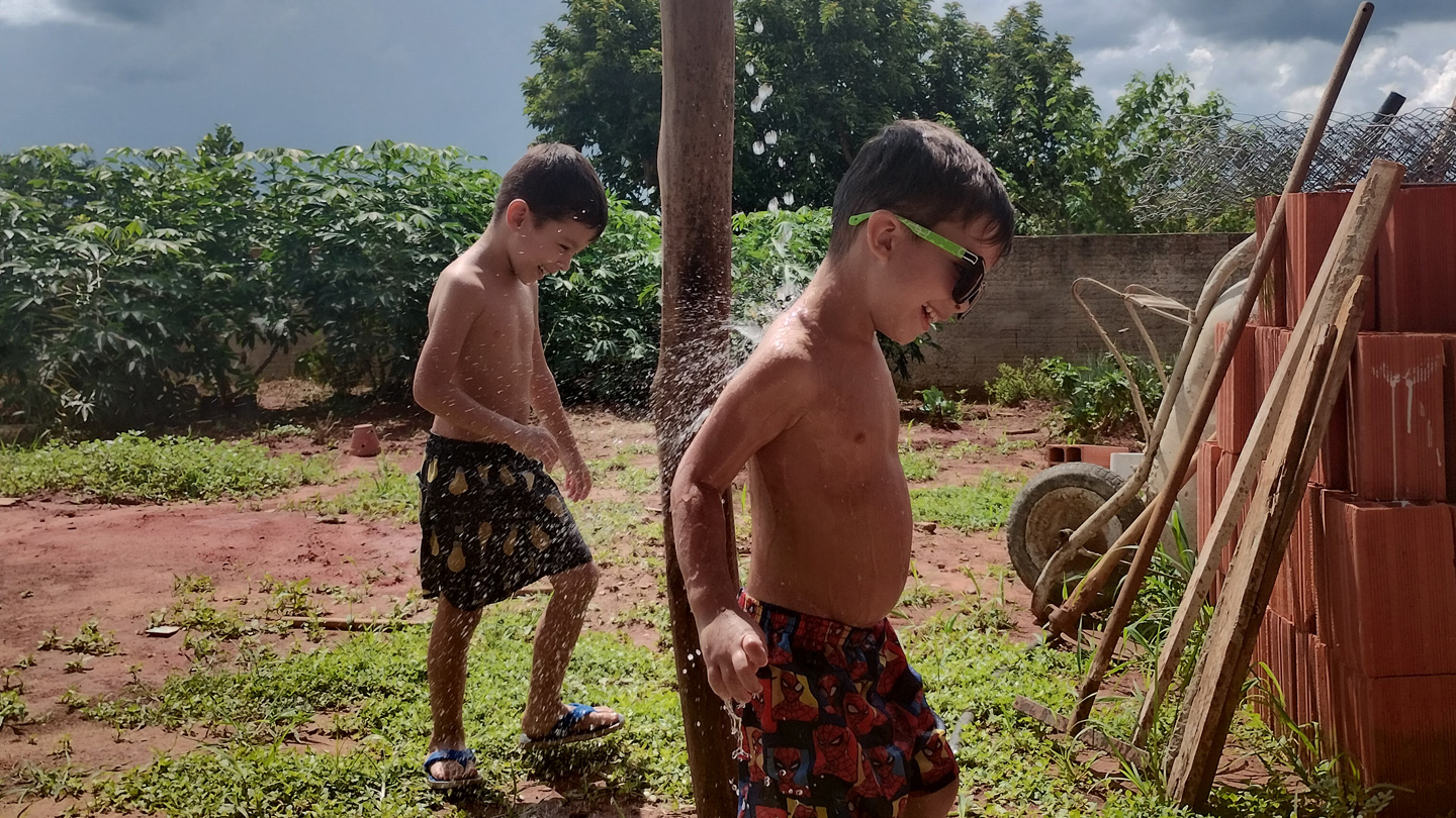 Twins playing with water in Brazil